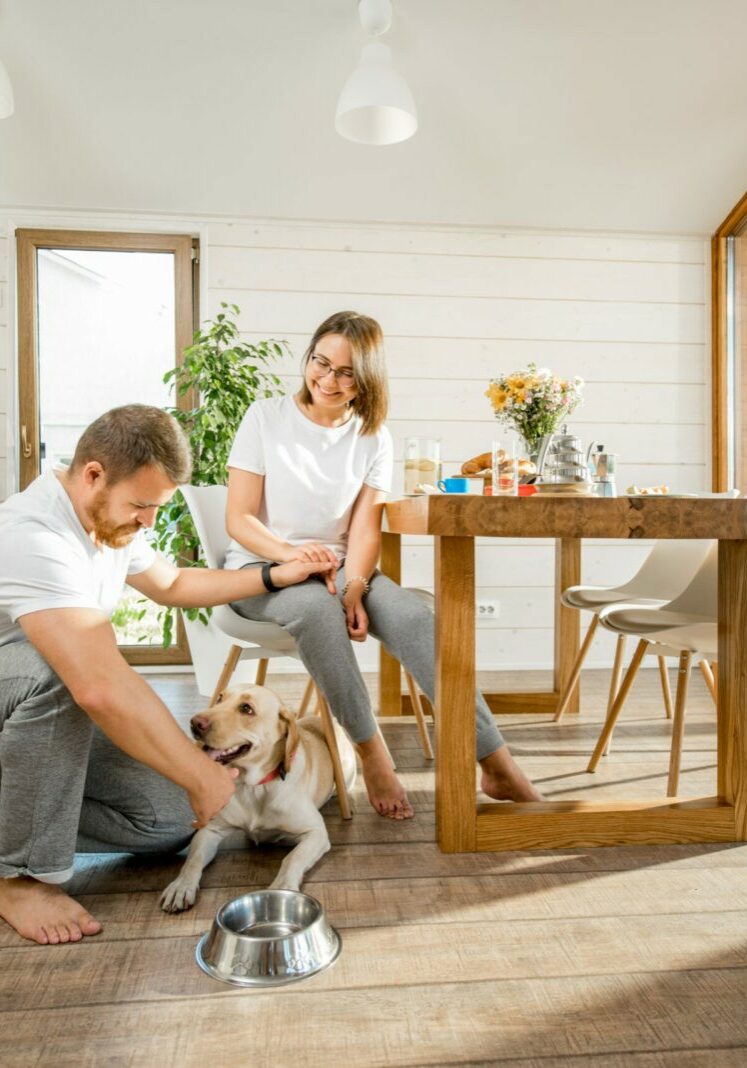 Young couple with dog at home | Floor to Ceiling Freeport